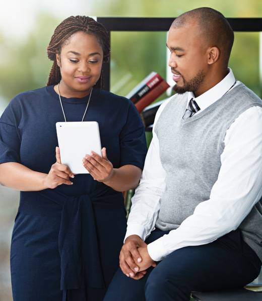 Portrait of businesswoman interacting with colleague in office